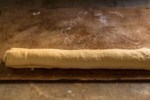 cinnamon bun dough rolled into a log shape