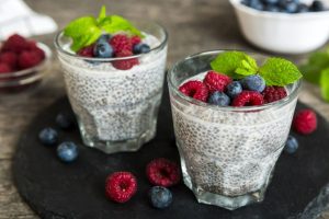 Chia seed pudding in a glass topped with fresh berries
