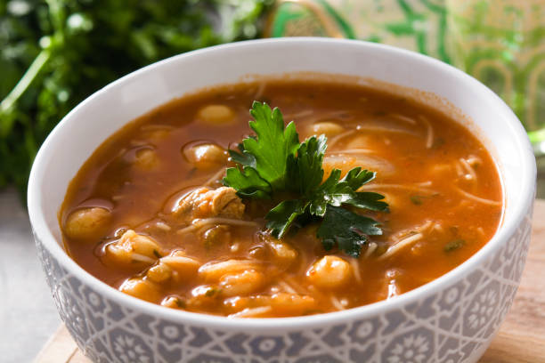 Harira soup in bowl on wooden table. Typical Moroccan food. Ramadan concept.