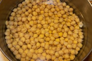 Closeup of dry chickpeas soaking in water