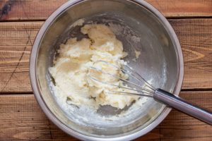 Step by step preparation of apple cake, step 2 - mixing butter and sugar, top view, horizontal