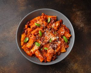 Traditional Italian Pasta e fagioli with bean, tomato and parmesan cheese.