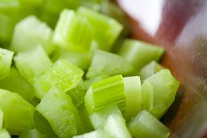 diced celery in brown bowl