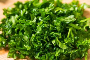 Raw Green Organic Minced Parsley on a Cutting Board