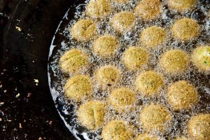 Balls of seasoned chick pea mixture are fried in oil to make falafel in a street-side stall in the West Bank town of Bethlehem.